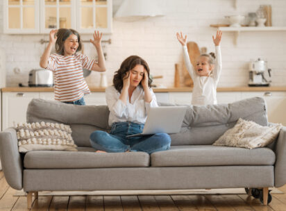 Woman,Working,On,A,Laptop.,Noisy,Children,And,Remote,Work