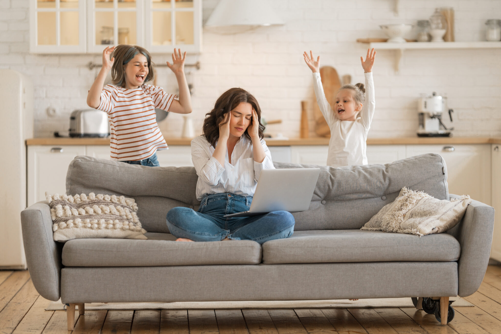 Woman,Working,On,A,Laptop.,Noisy,Children,And,Remote,Work